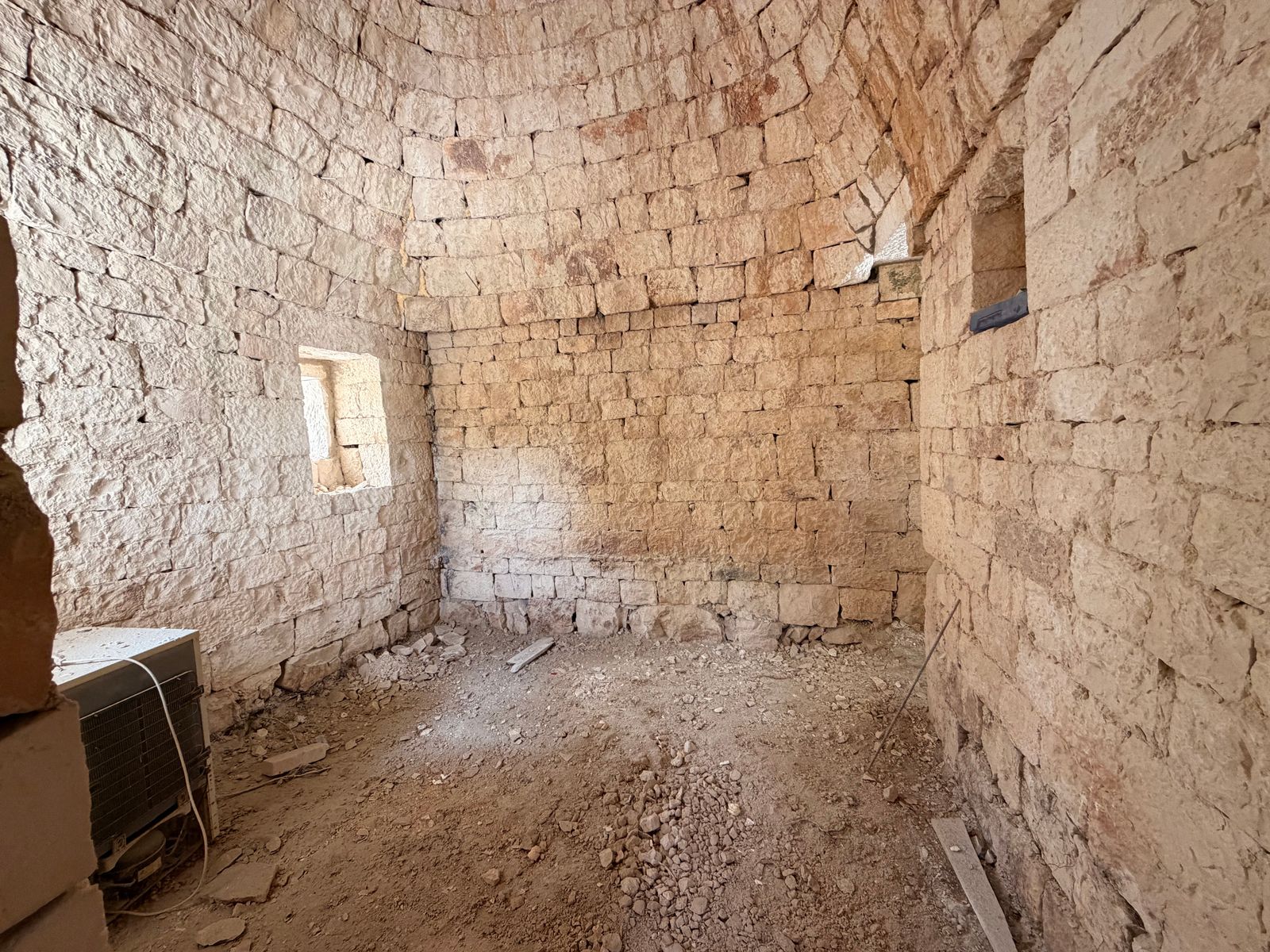 An interior stone arch with scaffolding during active restoration work
