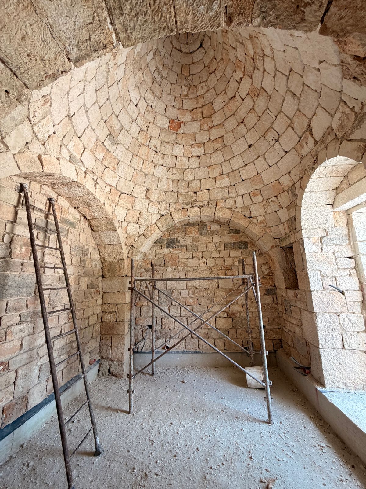 Vaulted interior of dry-stone construction lit by a single window